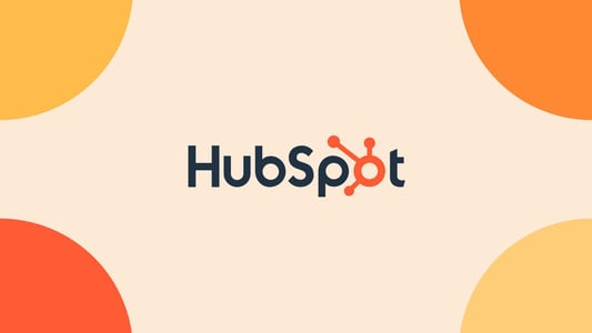 Blue and orange HubSpot logo against a beige background